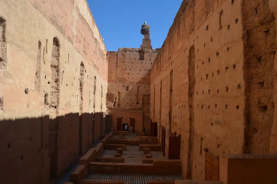 Ruins of El Badi Palace and storks nesting on sandstone walls